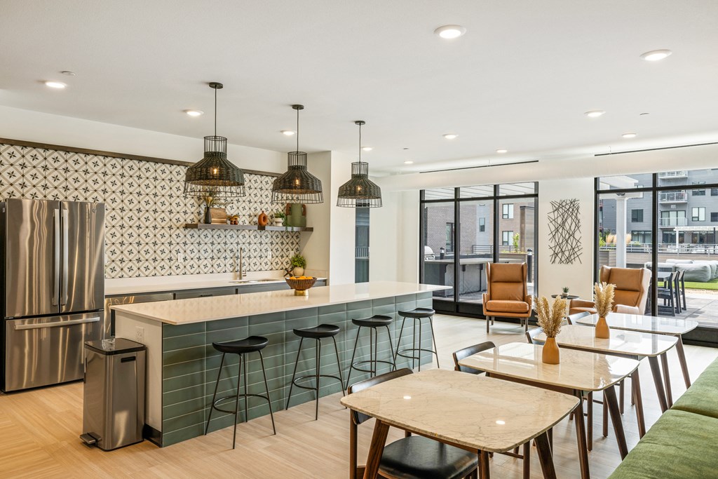 a kitchen and dining area with a counter and stools at EagleRidge Plaza Residences, North Dakota
