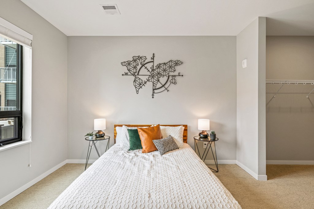 a bedroom with a bed and a wall art above it at EagleRidge Plaza Residences, Fargo