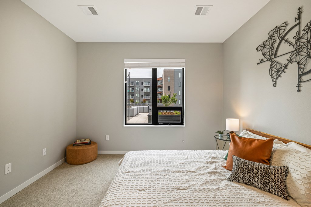 a bedroom with a large window and a bed at EagleRidge Plaza Residences, North Dakota, 58104