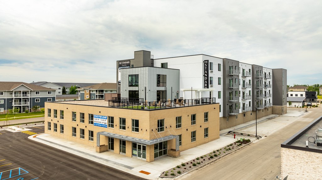 an aerial view of an apartment building with a rooftop terrace at The Standard on 32nd, North Dakota, 58078