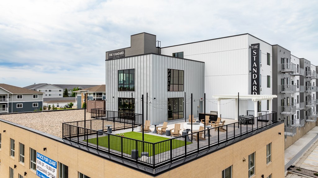 a rendering of a building with a rooftop terrace a rendering of a building with a rooftop terrace at The Standard on 32nd, West Fargo, ND