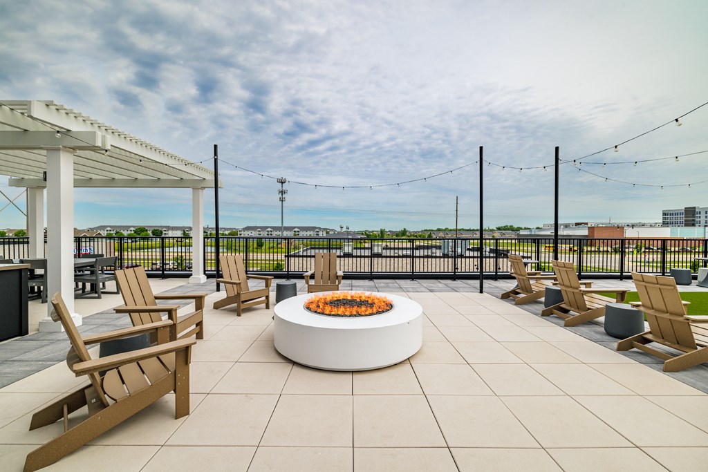 the terrace of a building with chairs and a fire pit at The Standard on 32nd, West Fargo, 58078