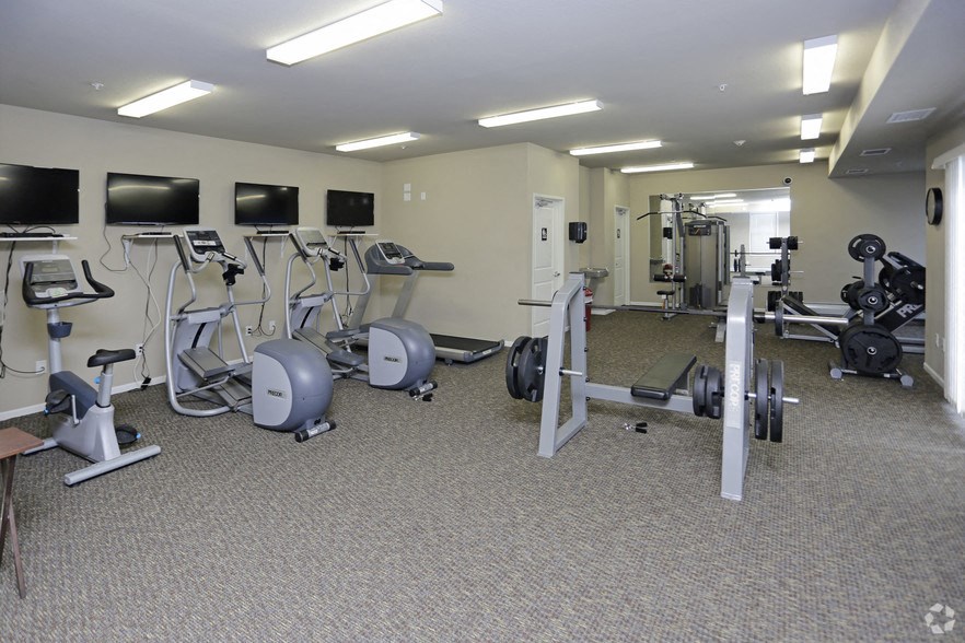 a gym with various exercise equipment in a building
