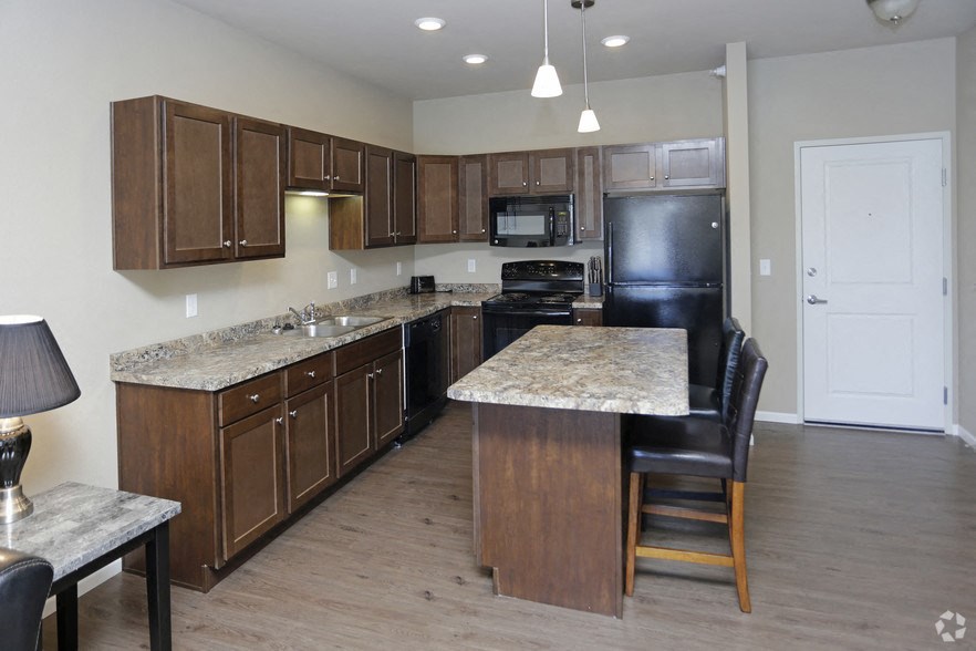 a large kitchen with wooden cabinets and granite counter tops