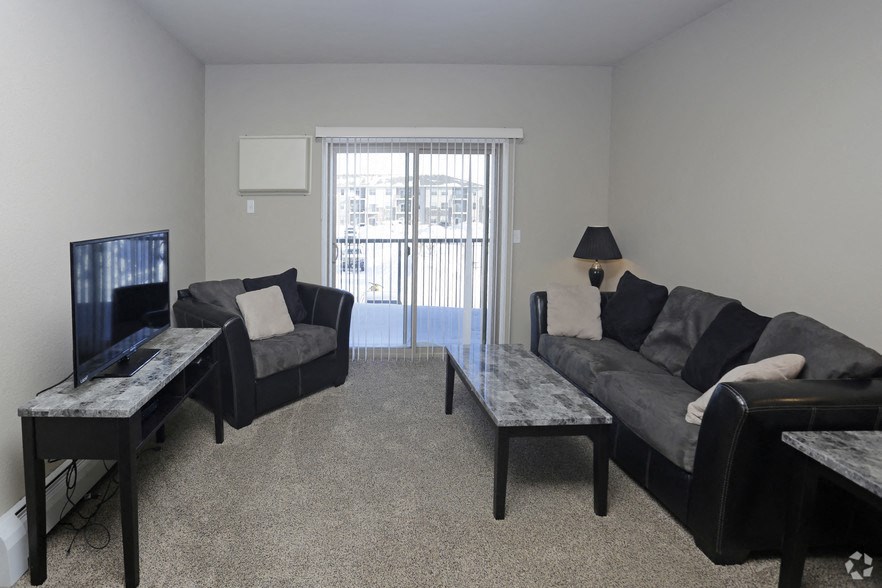 a living room with couches and a tv