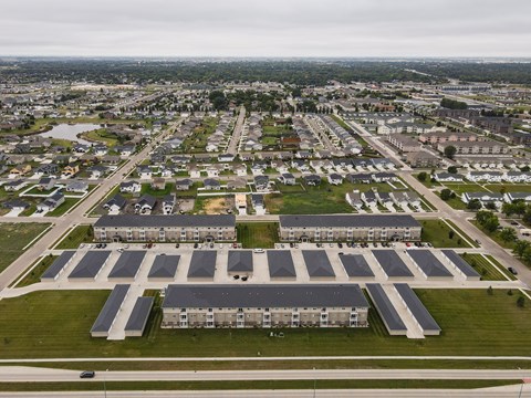 A large building complex with a parking lot in front.