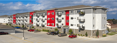 Apartment building with red and white balconies.