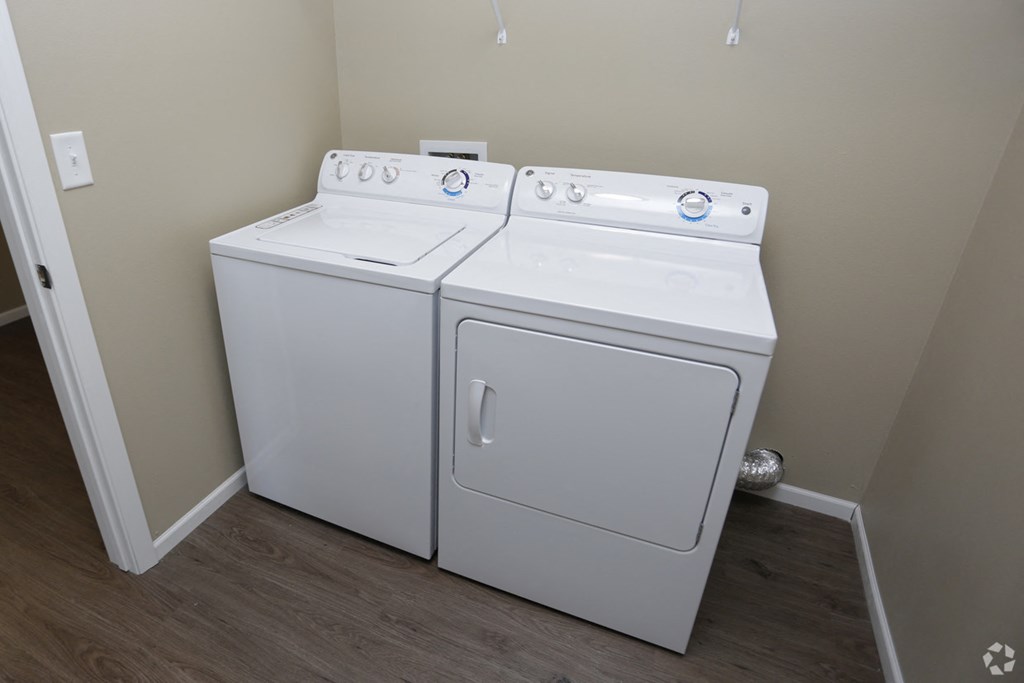 A white washer and dryer in a small laundry room.