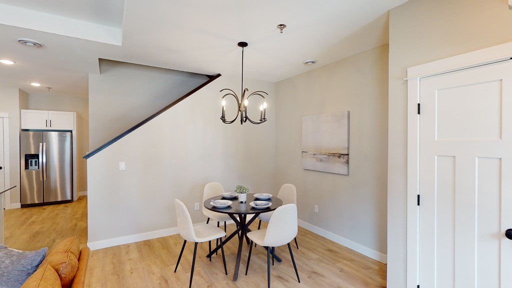 A dining room with a table set for two.