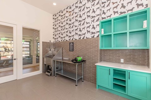A kitchen with a green counter and a brick wall.
