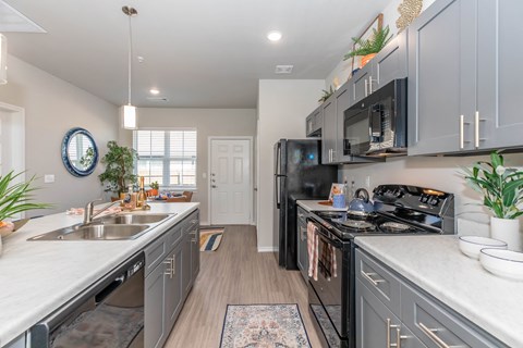 a kitchen with stainless steel appliances and white counter tops