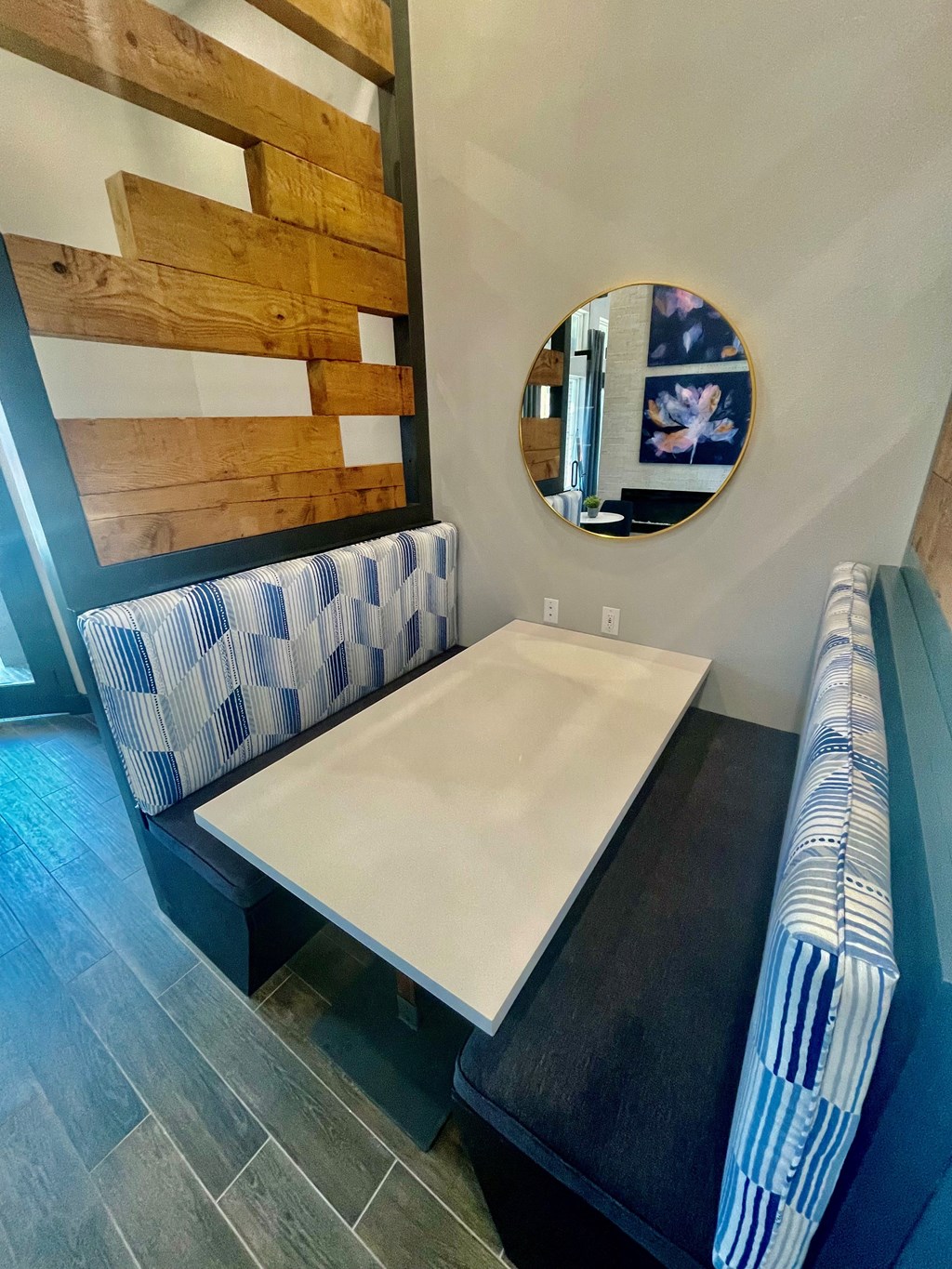 a dining room with a table and a mirror