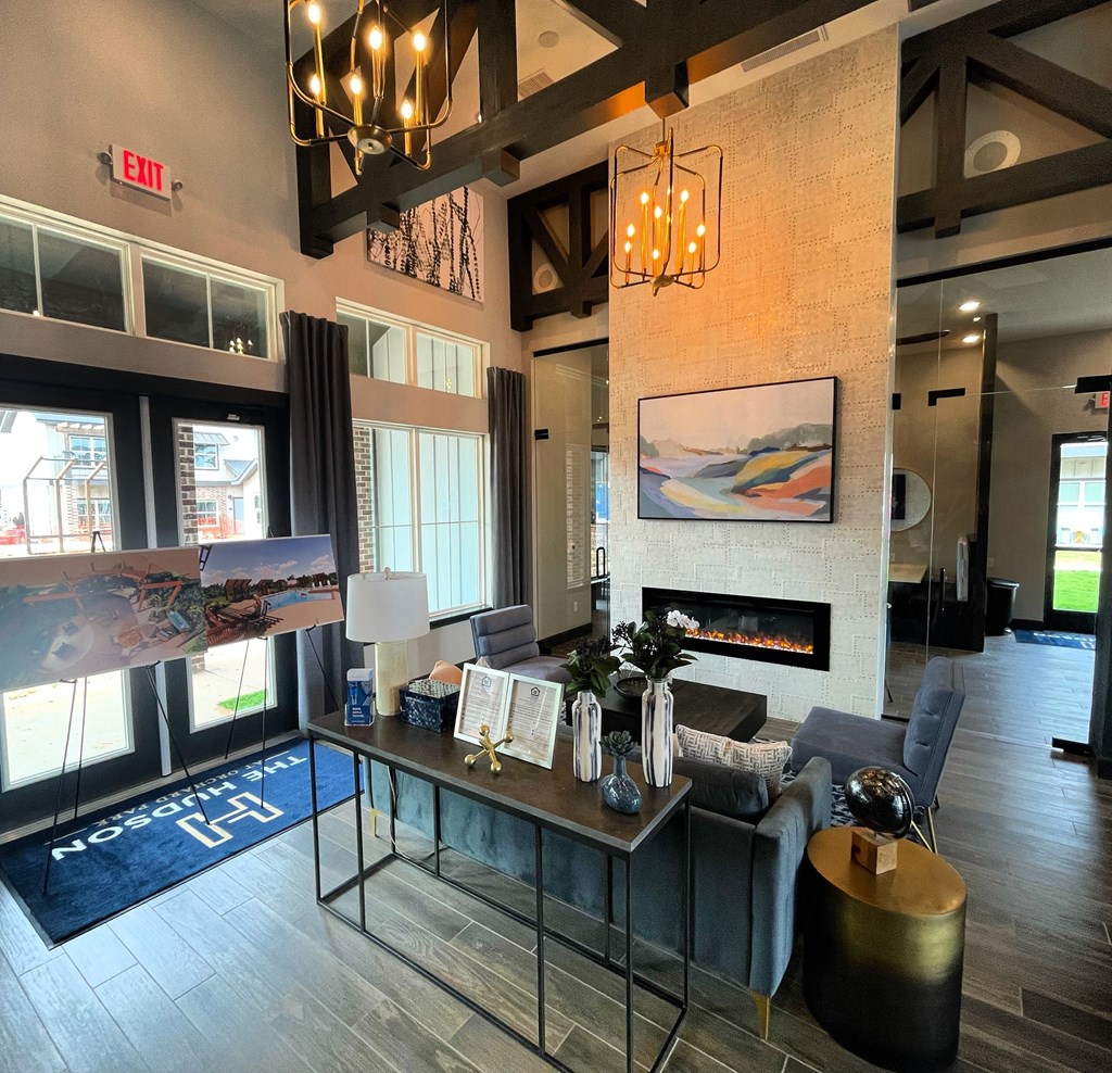 a living room with a couch and a table in front of a fireplace