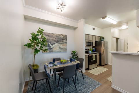 A dining room with a table set for four.