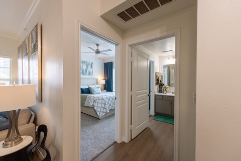 A bedroom with a bed and a ceiling fan.