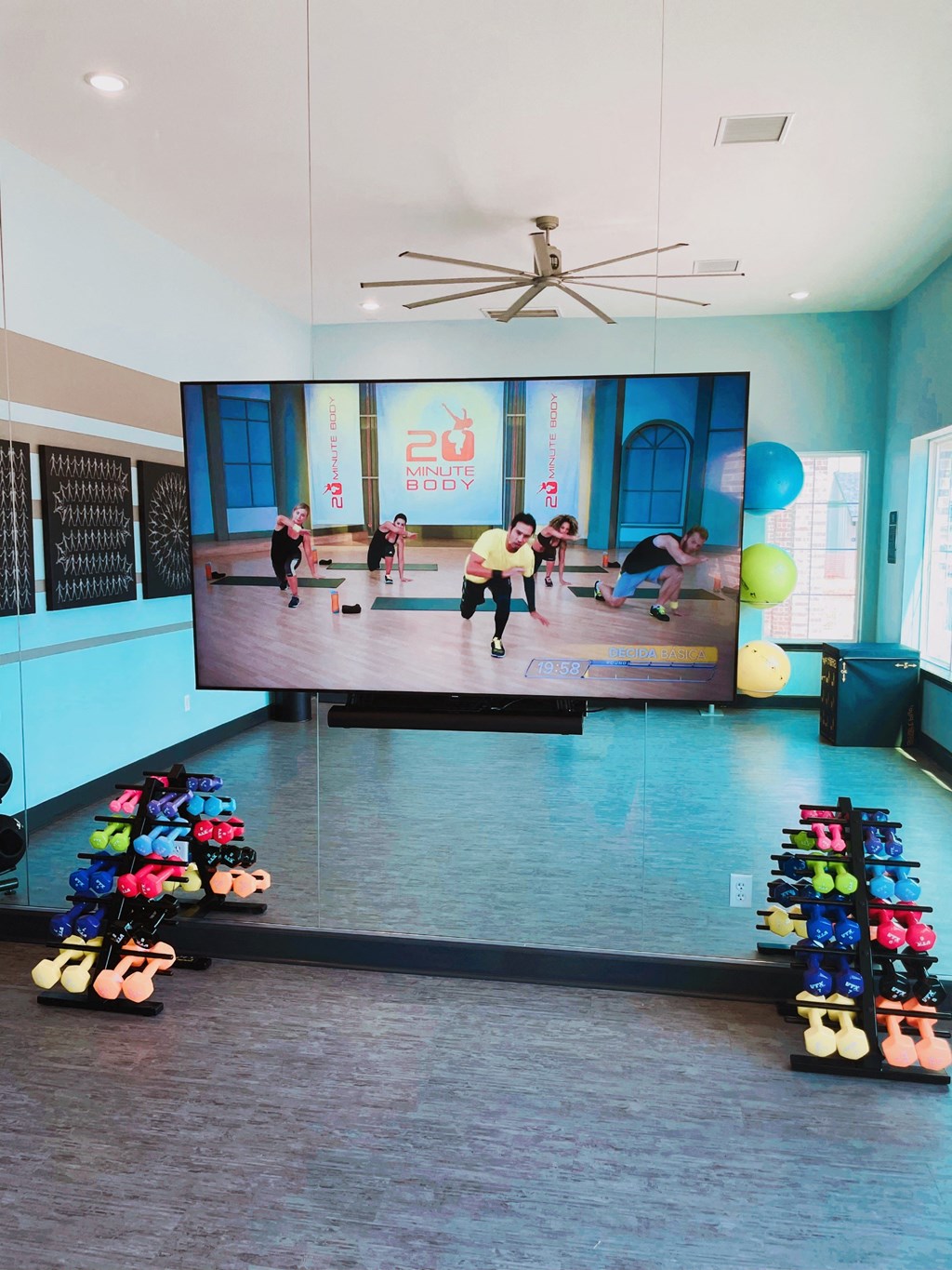 a room with a tv and a bunch of shoes on the floor