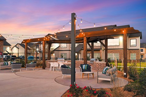 a patio with chairs and lights on a patio