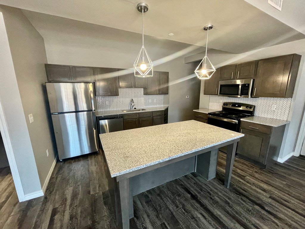 a kitchen with stainless steel appliances and a granite counter top