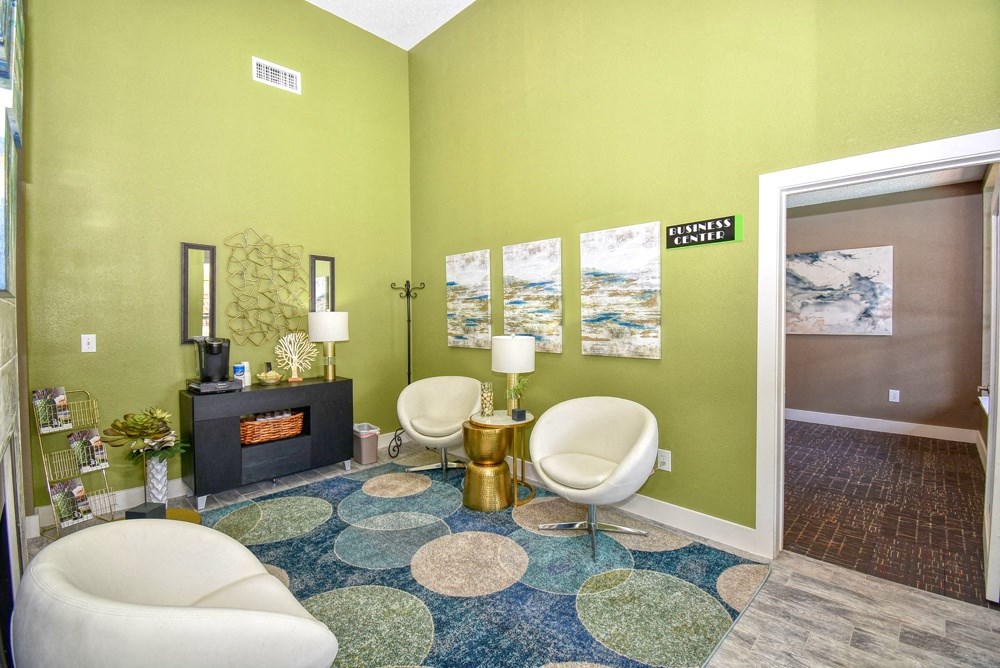 a living room with two chairs and a fireplace