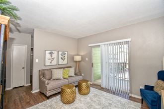 a living room with a couch and a door to a balcony