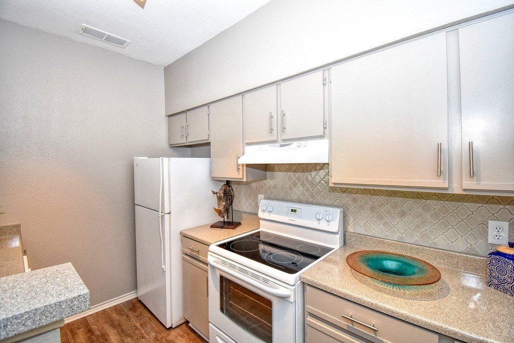 a kitchen with white appliances and white cabinets
