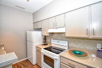a kitchen with white appliances and white cabinets
