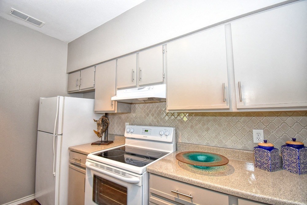 a kitchen with white appliances and white cabinets