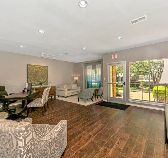a living room with a couch and a table with chairs