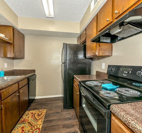 a kitchen with a stove refrigerator and sink