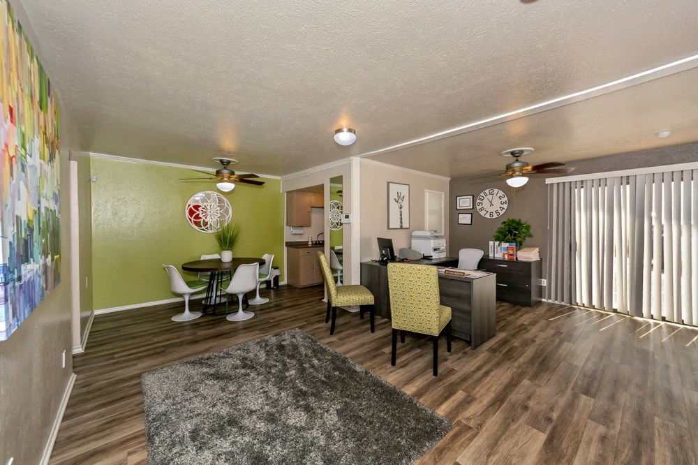 a living room and dining room with a table and chairs