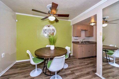 a dining room with a table and chairs and a kitchen