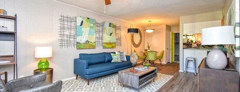 A living room with a blue couch and a coffee table.