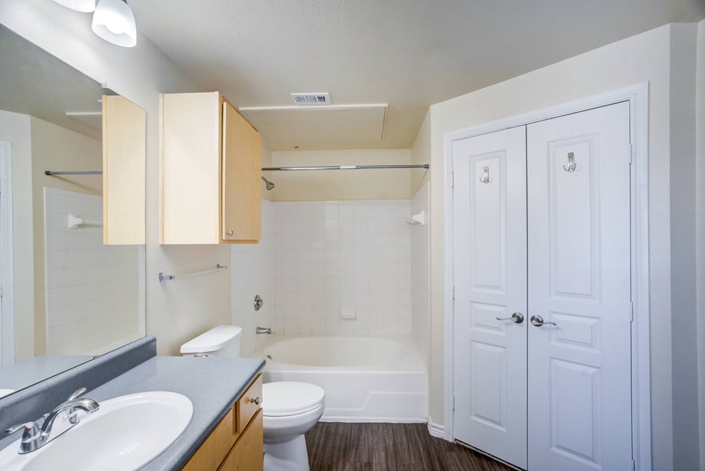 A white bathroom with a toilet, sink, and bathtub.