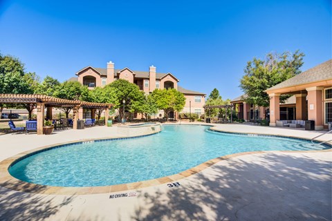 Swimming pool and clubhouse at Dakota Arms apartments in Lubbock.