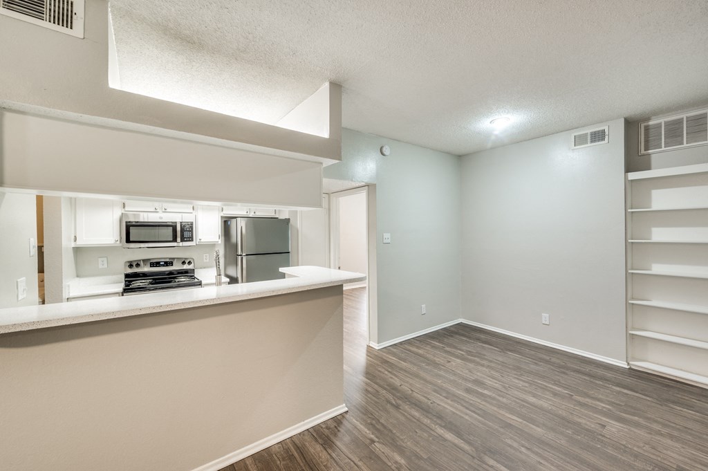 an open kitchen and living room with a counter top and