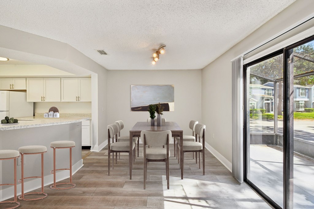 A kitchen with a bar area and a dining table.