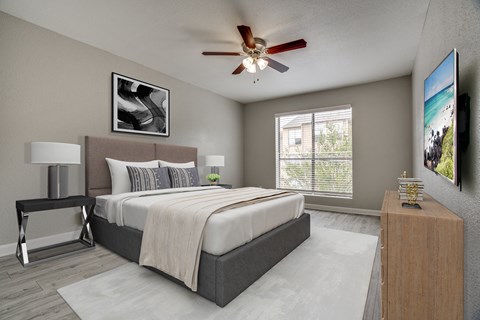 a bedroom with a large bed and a ceiling fan