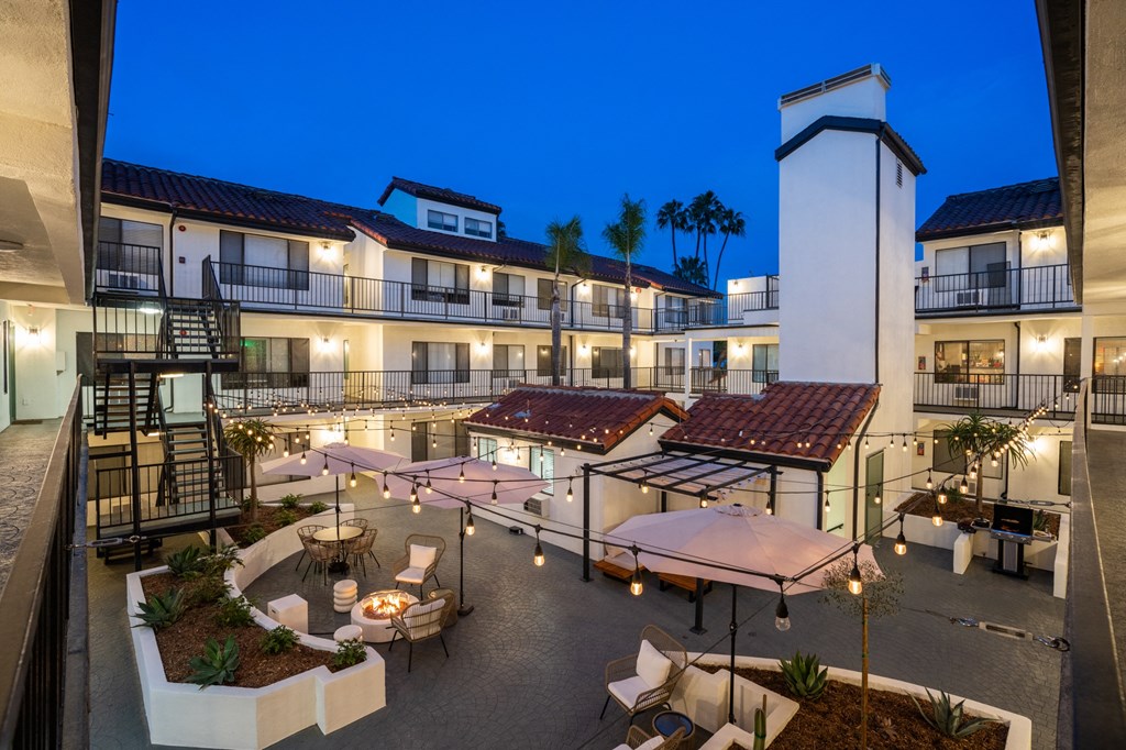 a view of the courtyard of a hotel at night