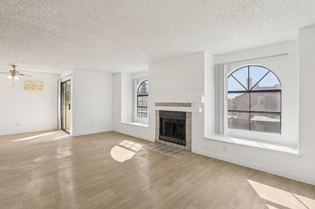 A living room with a fireplace and a window.