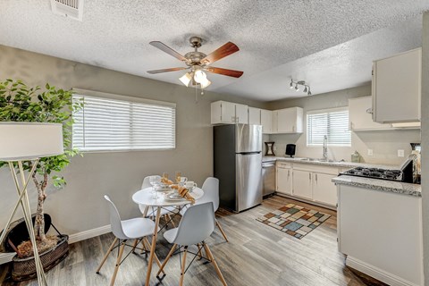 an open kitchen and dining room with a white table and chairs