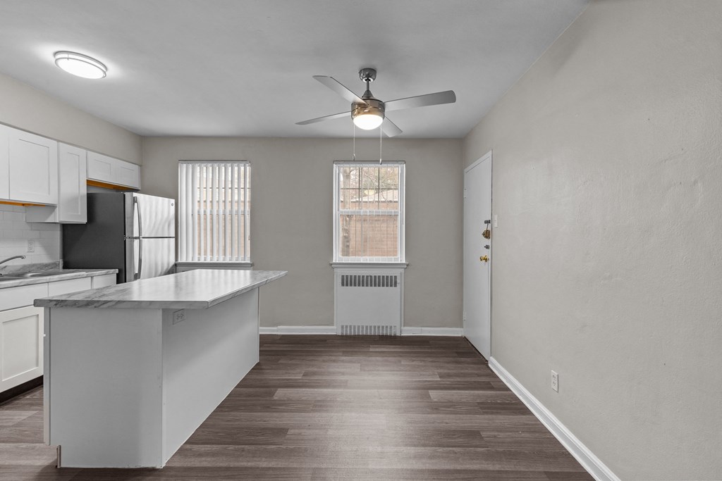 an empty kitchen with an island and a ceiling fan at Hampton Gardens, Missouri, 63139