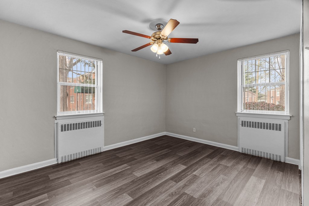 an empty living room with two windows and a ceiling fan at Hampton Gardens, Missouri, 63139