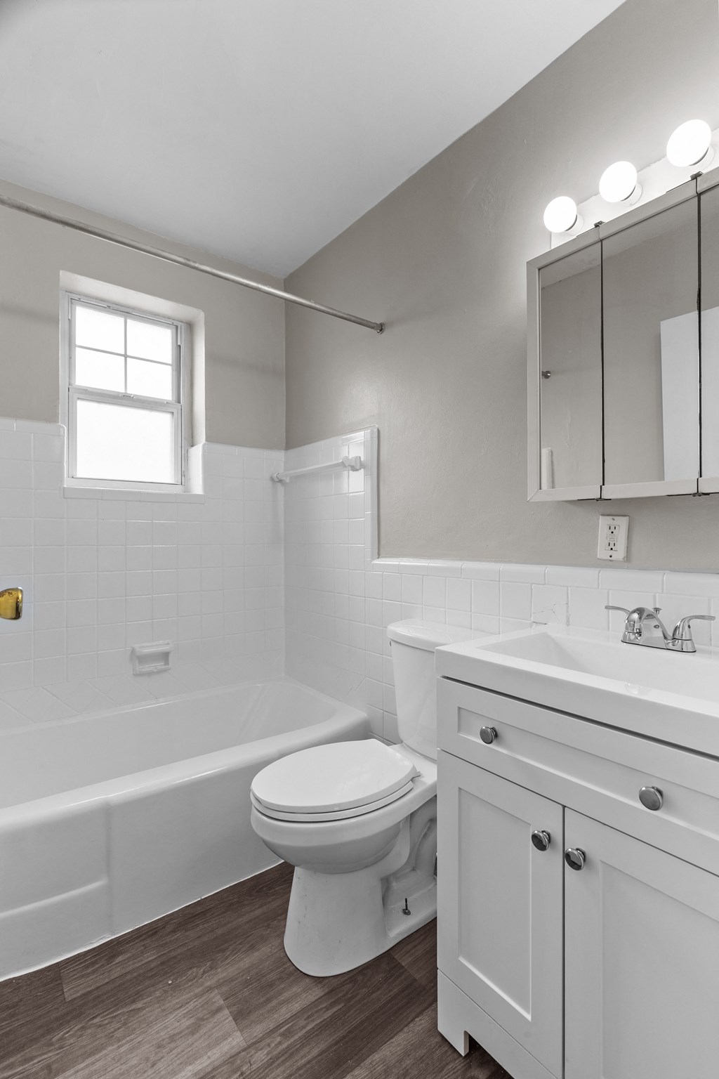 a white bathroom with a toilet and a bath tub