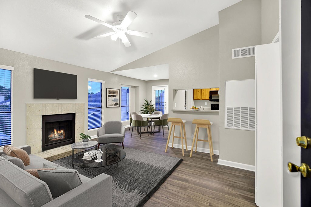 A modern living room with a fireplace and a flat screen TV. at Seacrest Apartments, Garland