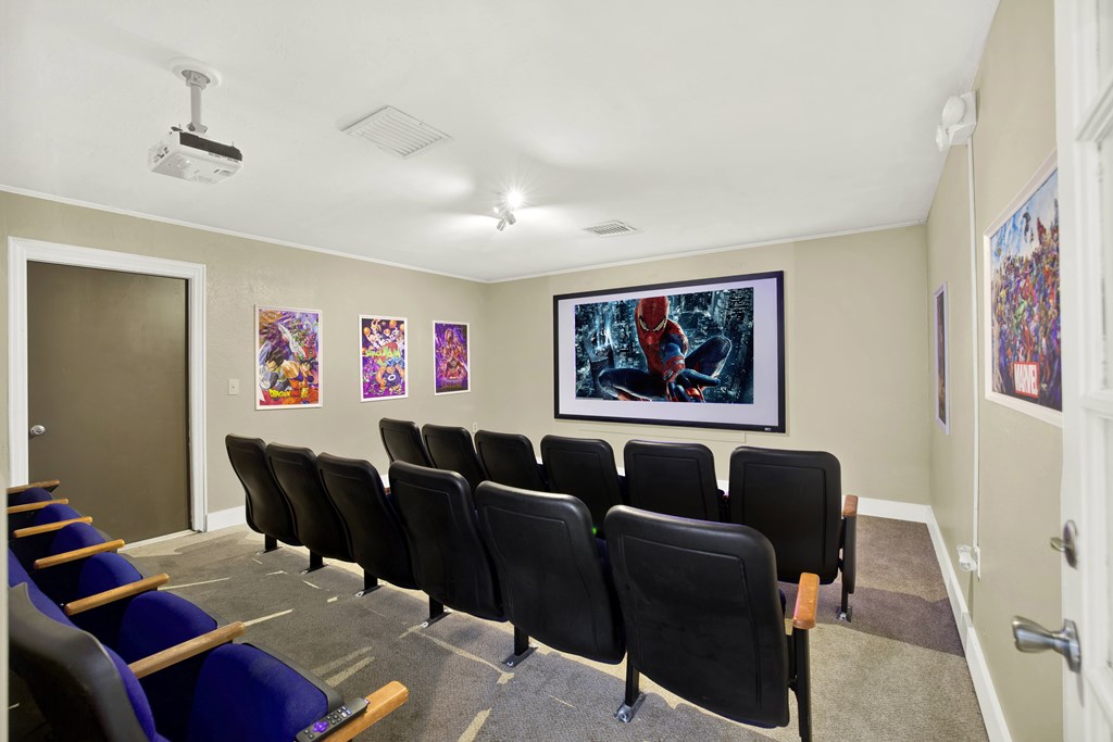 A room with a row of chairs and a painting on the wall.