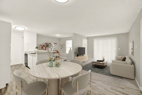 A modern living room with a dining table and chairs.