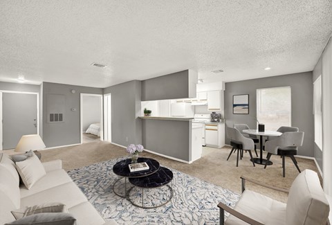 A living room with a couch, chairs, and a coffee table.