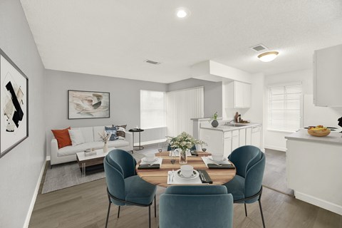 A modern dining room with a white table and blue chairs.