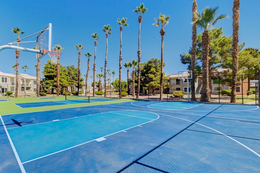 two blue basketball courts with palm trees and apartments in the background at Citrus Apartments, Las Vegas, Nevada, 89101