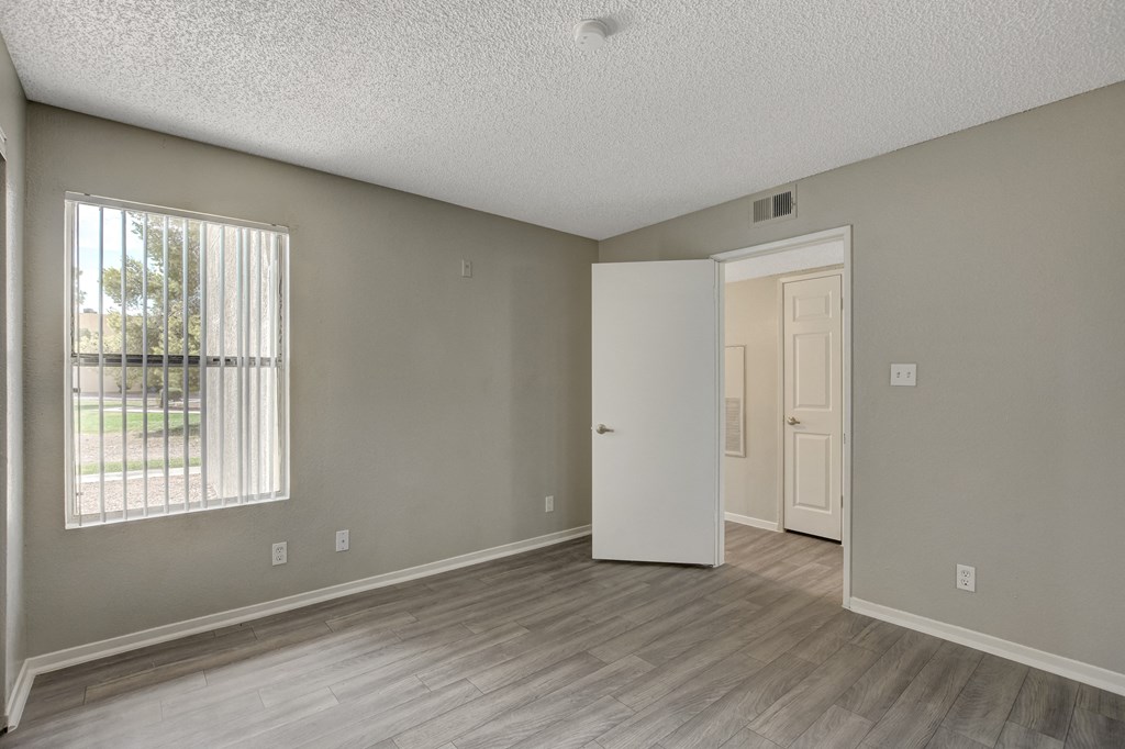 bedroom with large window at Citrus Apartments, Las Vegas, NV